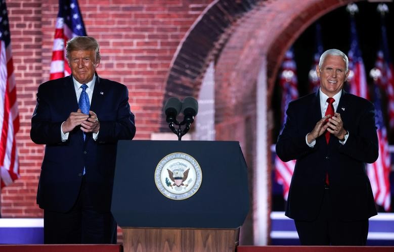U.S. Vice President Mike Pence is joined onstage by U.S. President Donald Trump after delivering his acceptance speech as the 2020 Republican vice presidential nominee during an event of the 2020 Republican National Convention held at Fort McHenry in Baltimore, Maryland. REUTERS/Jonathan Ernst